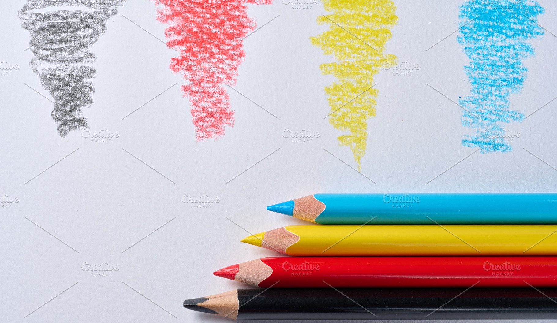 Four colored pencils lying on white paper, with a stroke of the, a School & Education Photo by ndanko