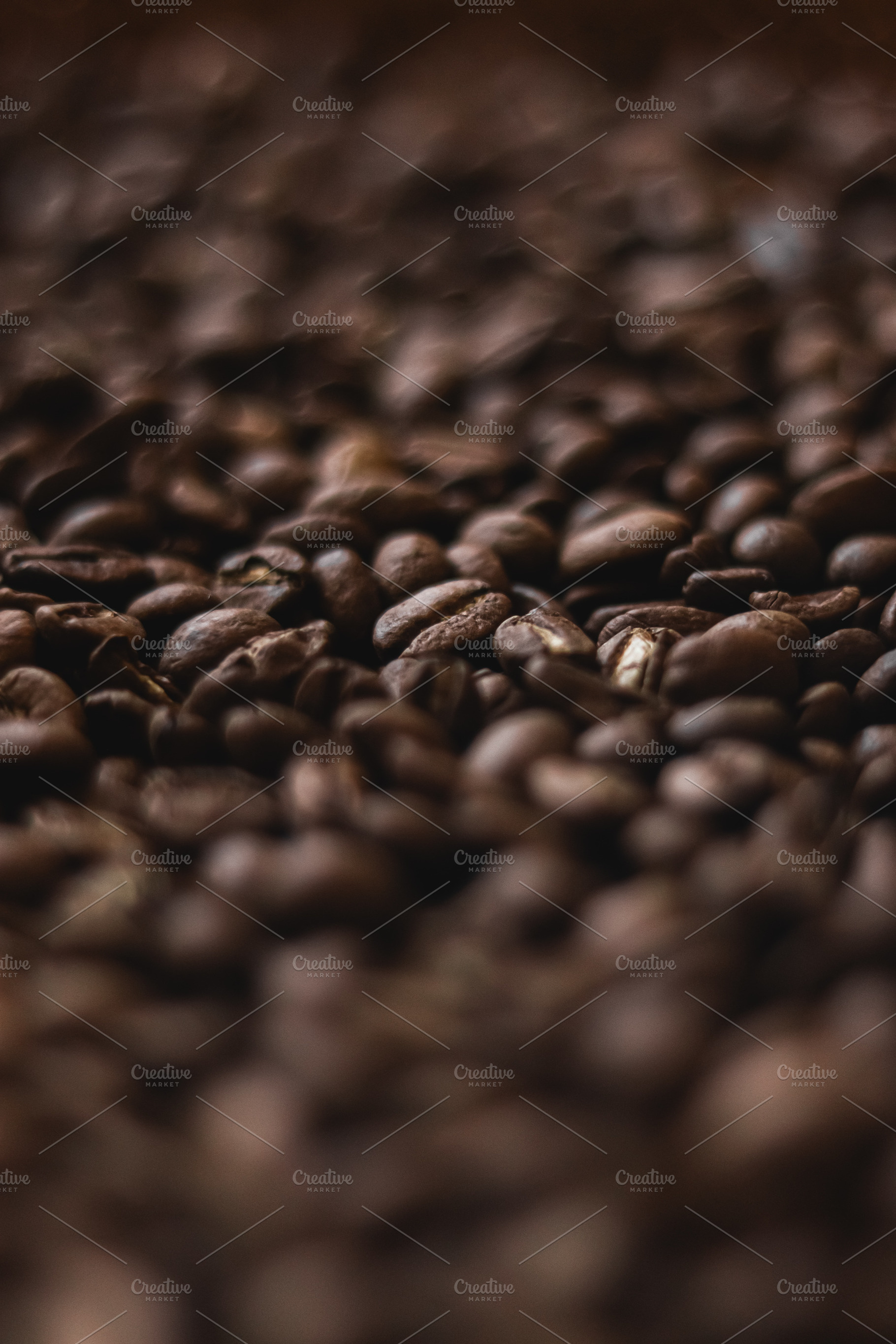 Roasted coffee beans scattered, forming a textured background. A, a Photo by Studio ANNA
