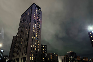 Night view of tall residential tower in Manchester city at night with illuminat, a Photo by AS photostudio