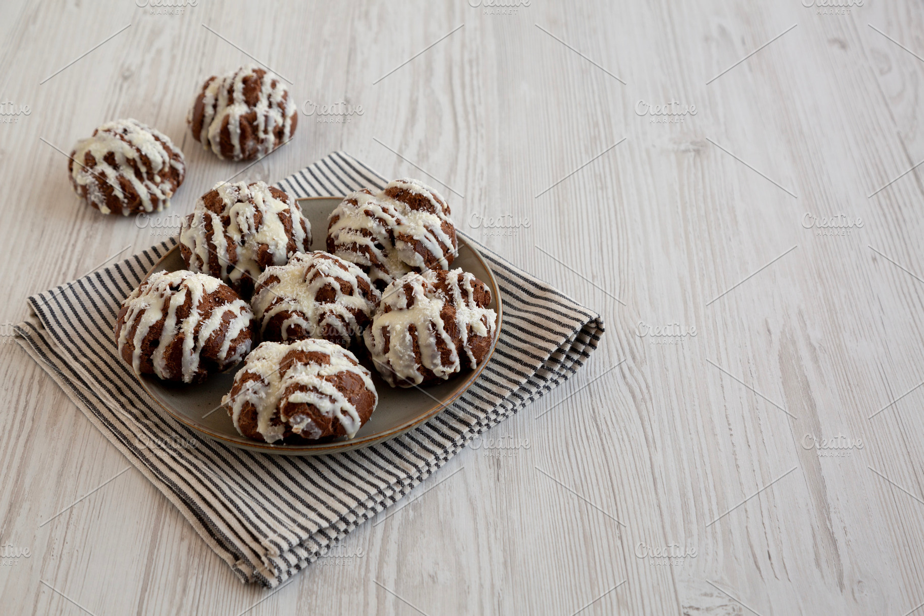 Homemade Profiteroles with Coconut Cream on a Plate, side view., a Food & Drink Photo by LiudmylaChuhunova