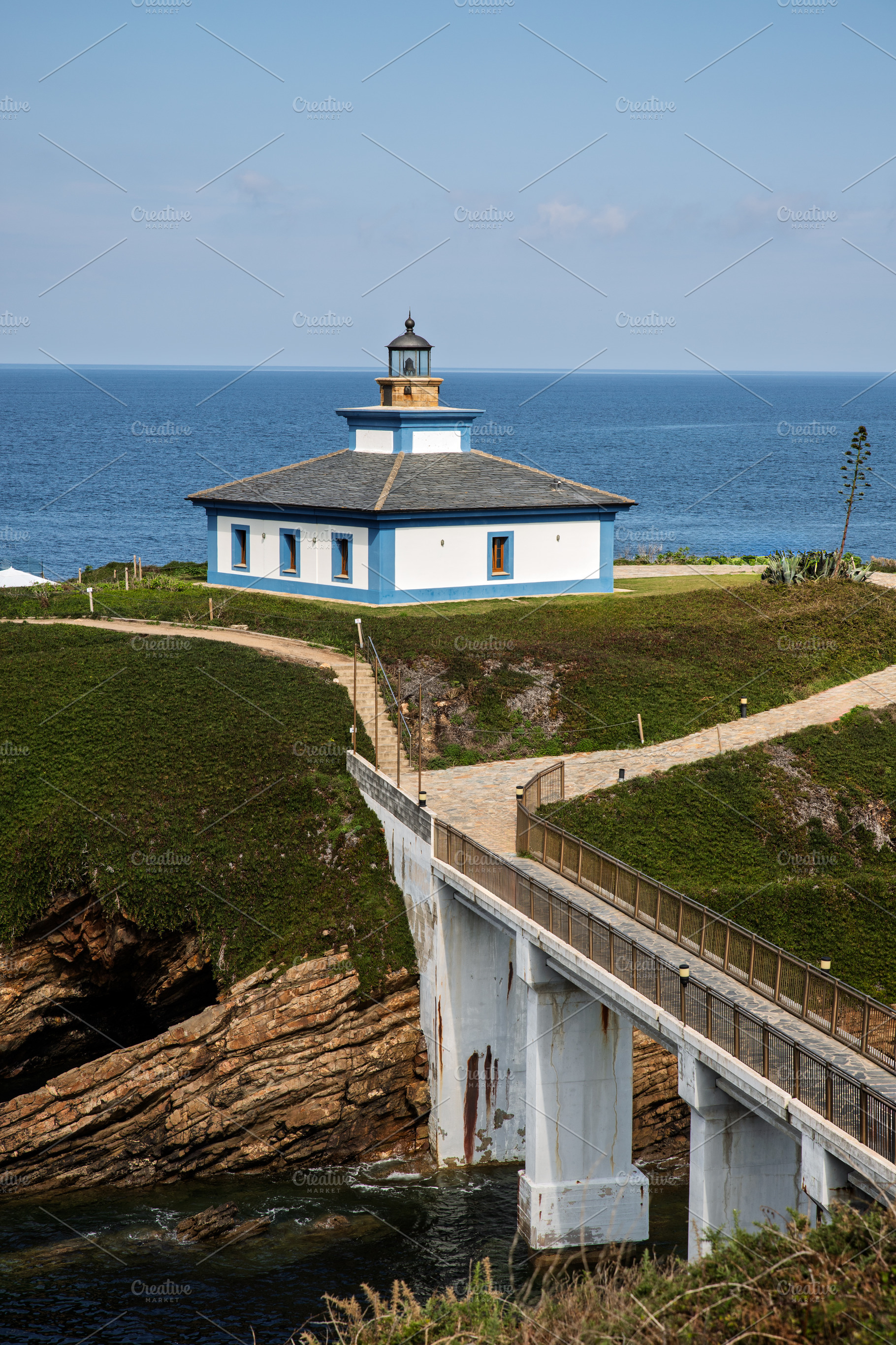 Lighthouse on an islet with a bridge, a Holiday Photo by Perpis