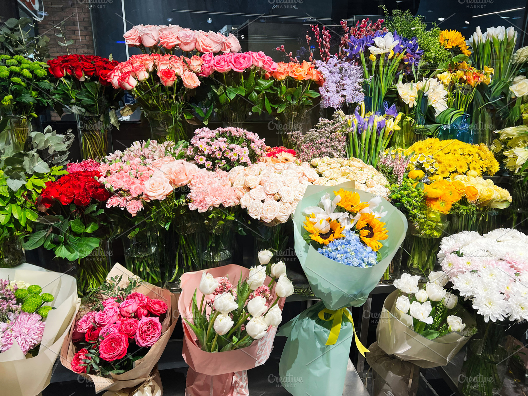 Colorful floral arrangement display at a market showcasing vibrant bouquets and, a Photo by AS photostudio