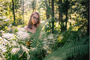 Woman Among Forest Ferns in Sunlight, a Person Photo by Jan Jack Russo Media