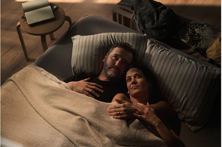 Mid-adult couple lying in bed at, a Person Photo by HalfPoint