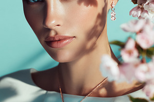 Woman's portrait with cherry blossoms and rose gold jewelry, exp, a Photo by Studio ANNA