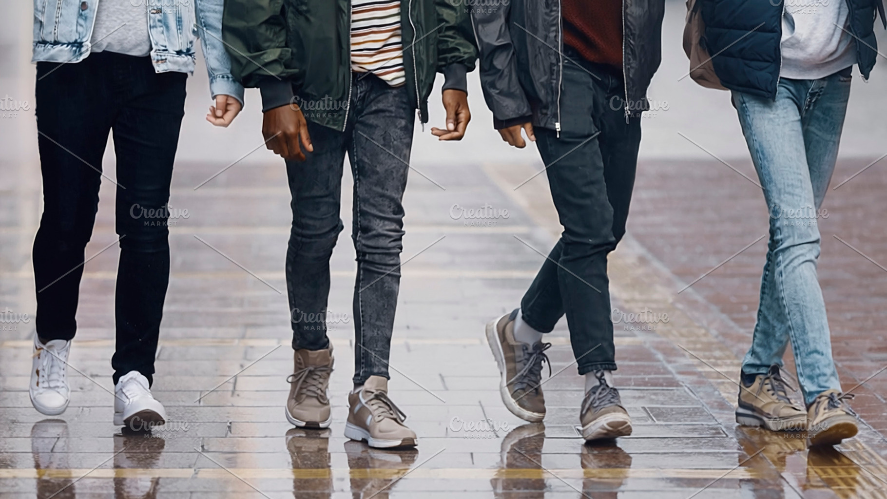 Group of five teenager walking on wet street, a Photo by DanFLCreativo