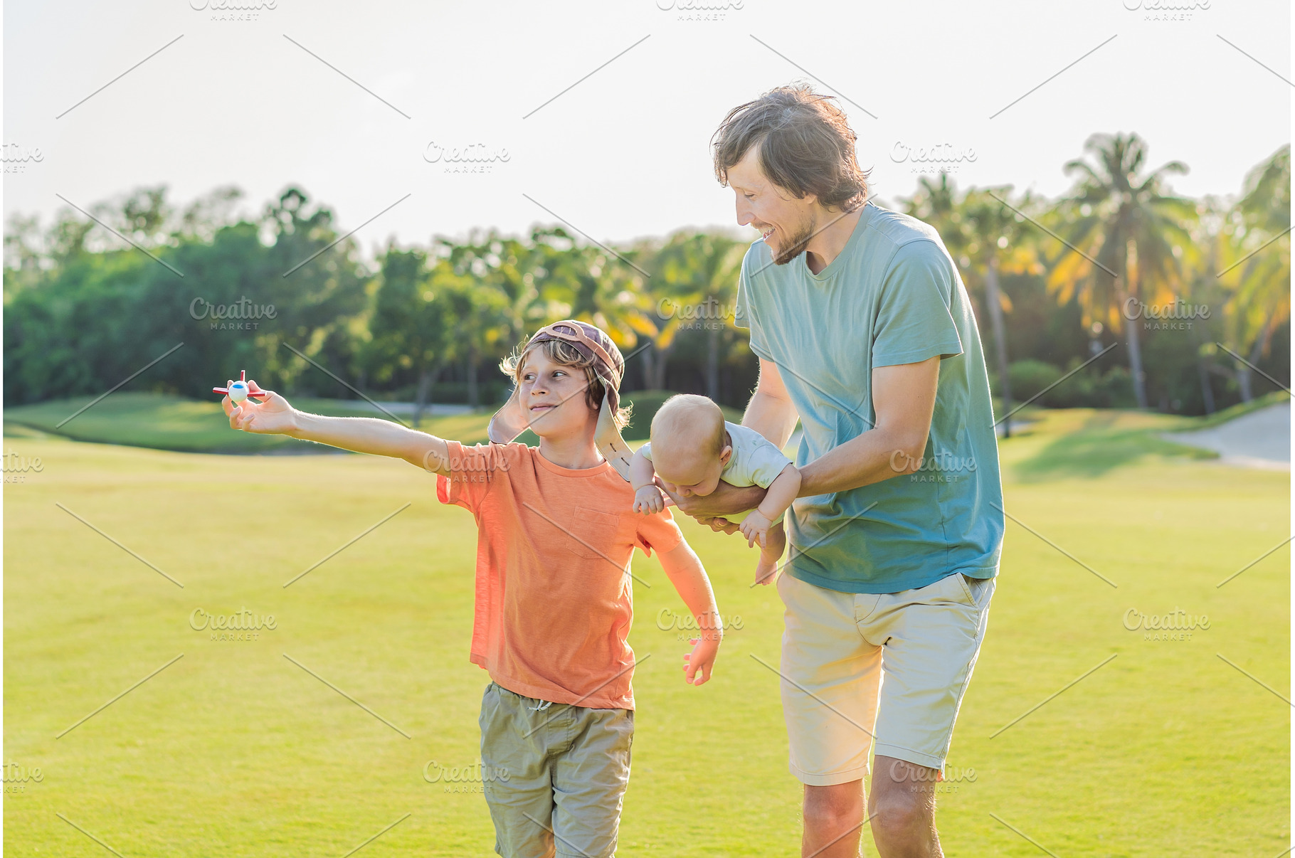 Father with his two sons in the park, a Person Photo by Elizaveta Galitskaya