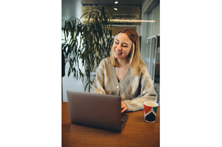 Girl working at her laptop sitting, a Person Photo by zheckasmk