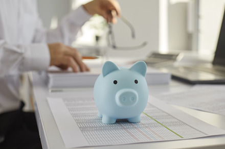 Blue piggy bank on table with a, a Business Photo by StudioRomantic