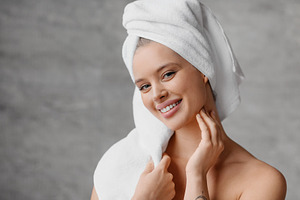 Home skincare concept. Portrait of pretty woman with perfect skin smiling at ca, a Photo by Prostock-Studio