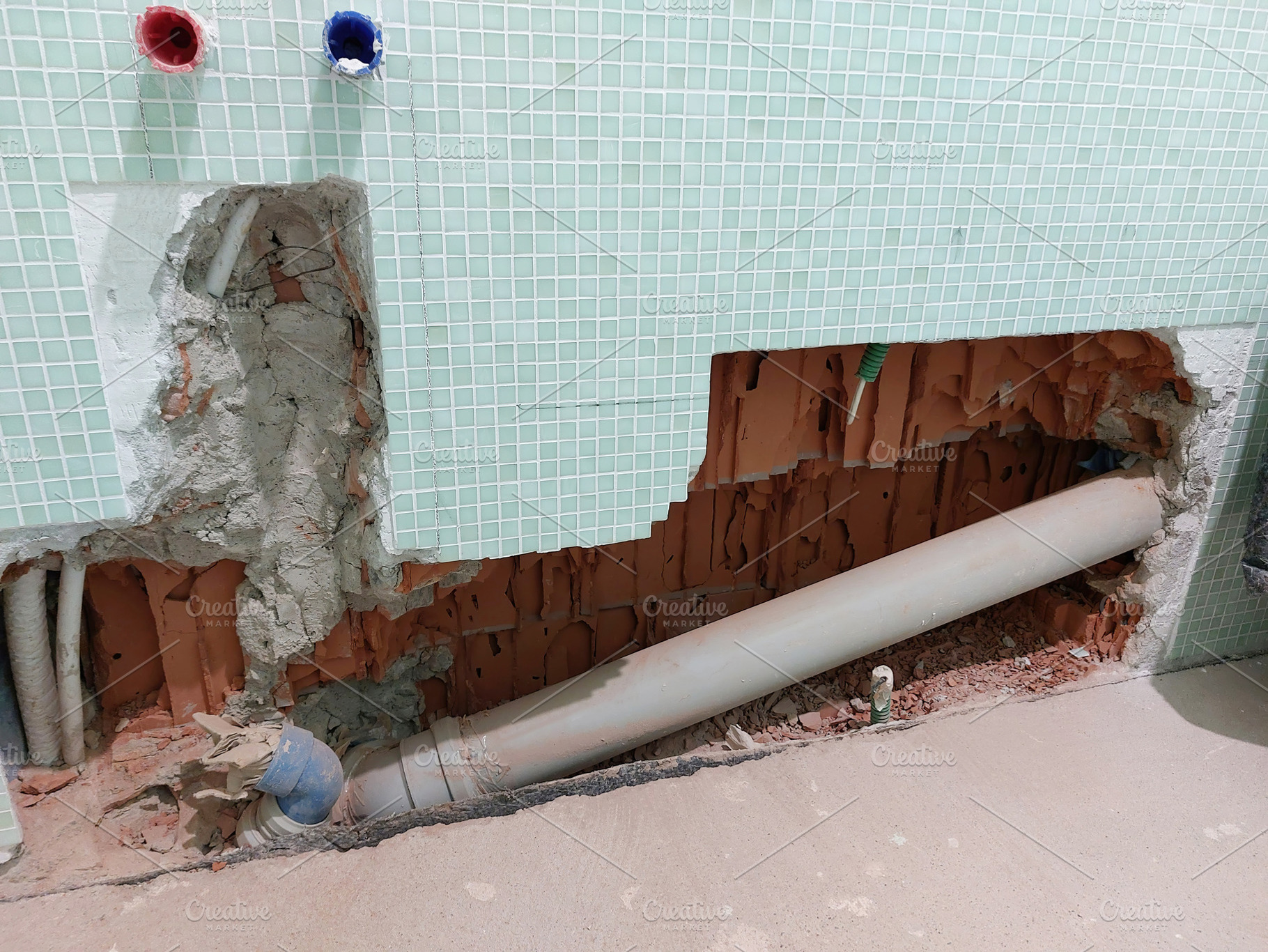 Plumber replacing toilet drain pipe during bathroom renovation, an Architecture Photo by Antonio Gravante Market