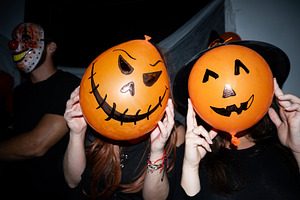 Friends posing with pumpkin balloons at Halloween party, a Holiday Photo by etorres69