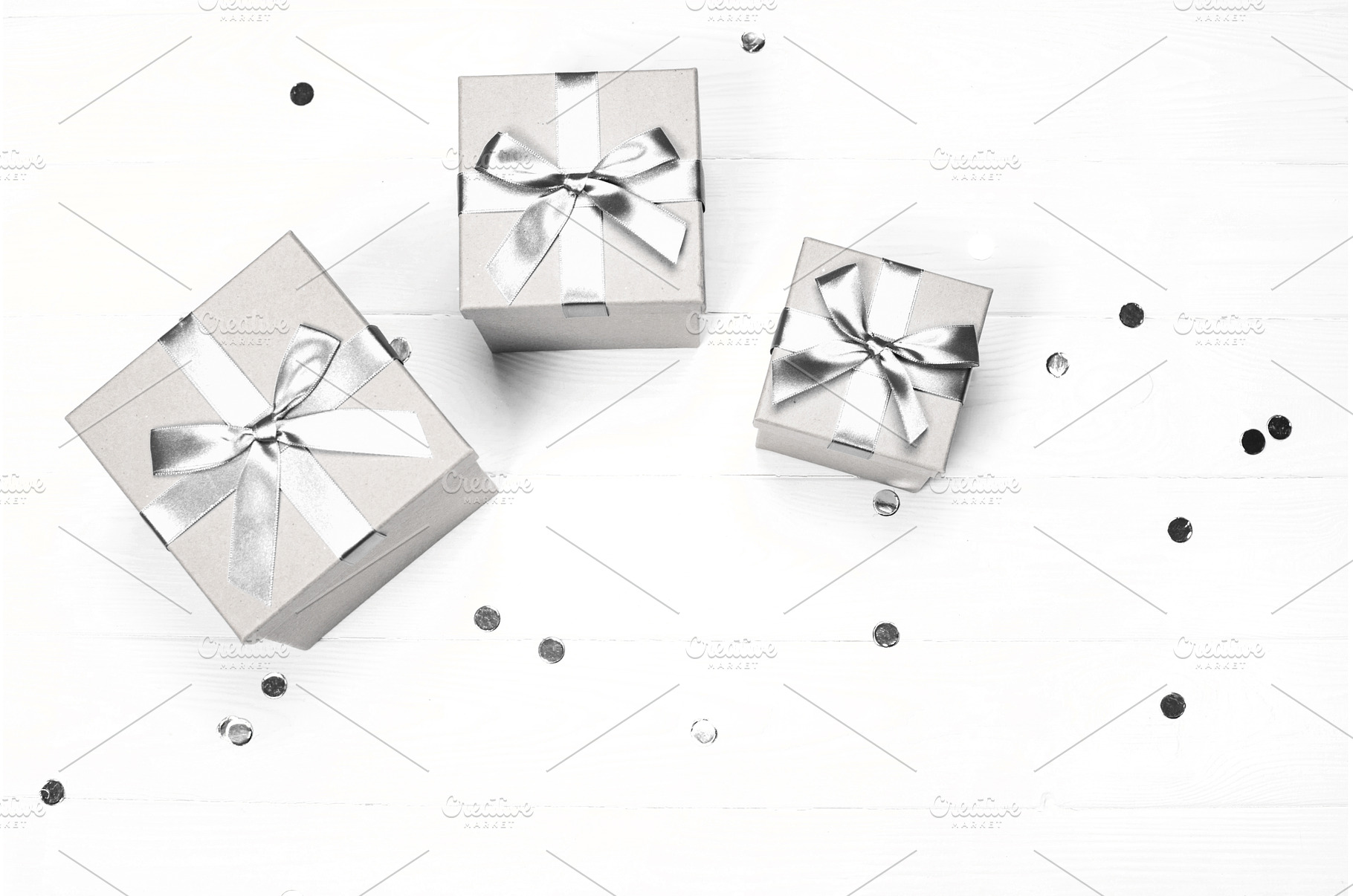 Silver gift boxes and confetti on, a Holiday Photo by Anna Efetova
