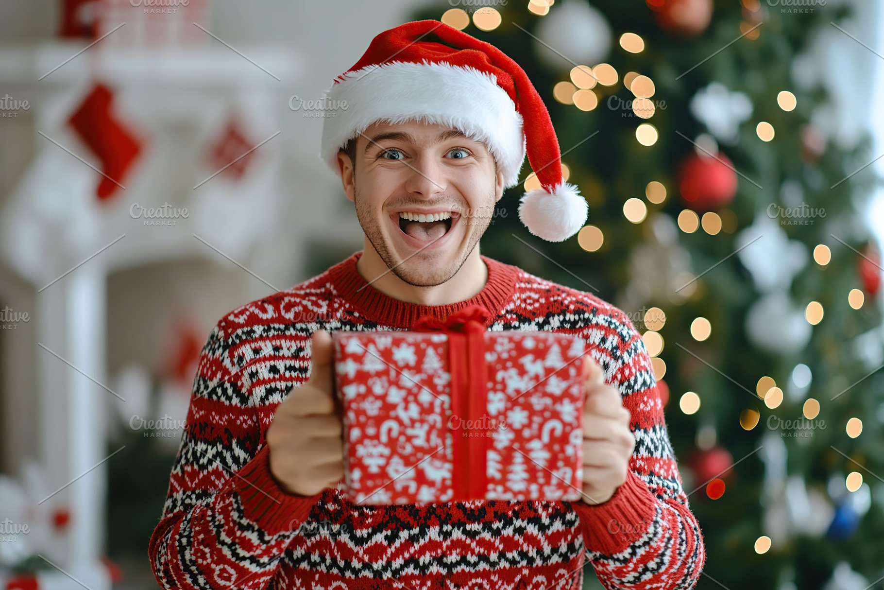 Happy young man in christmas sweater and santa hat holding in hands gift box on, a Holiday Photo by AlyaAnd