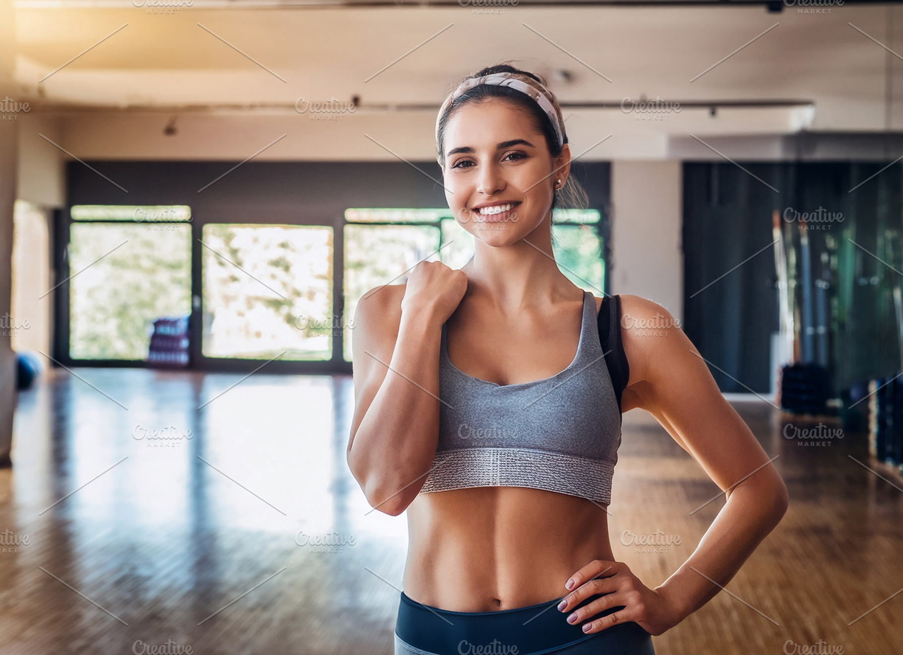 Smiling girl in sportswear in a sports room, a Sports & Recreation Photo by Davizro's Market
