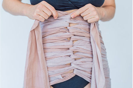 Postpartum woman wraps her belly, a Person Photo by Elizaveta Galitskaya