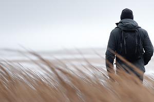Man in dark jacket and backpack walk, a Person Photo by MistyDay