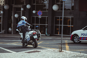 Unrecognizable Officer Mounting Bike, a Person Photo by SkyNext