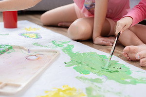 Sisters Painting on Large Paper at Home, a Person Photo by etorres69