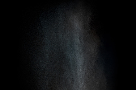 Dust particles over black background, a Background Photo by Tuomas Kujansuu Photos
