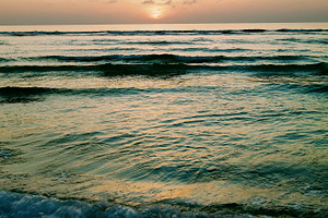 Ocean sunset featuring sunset, beach, and sea