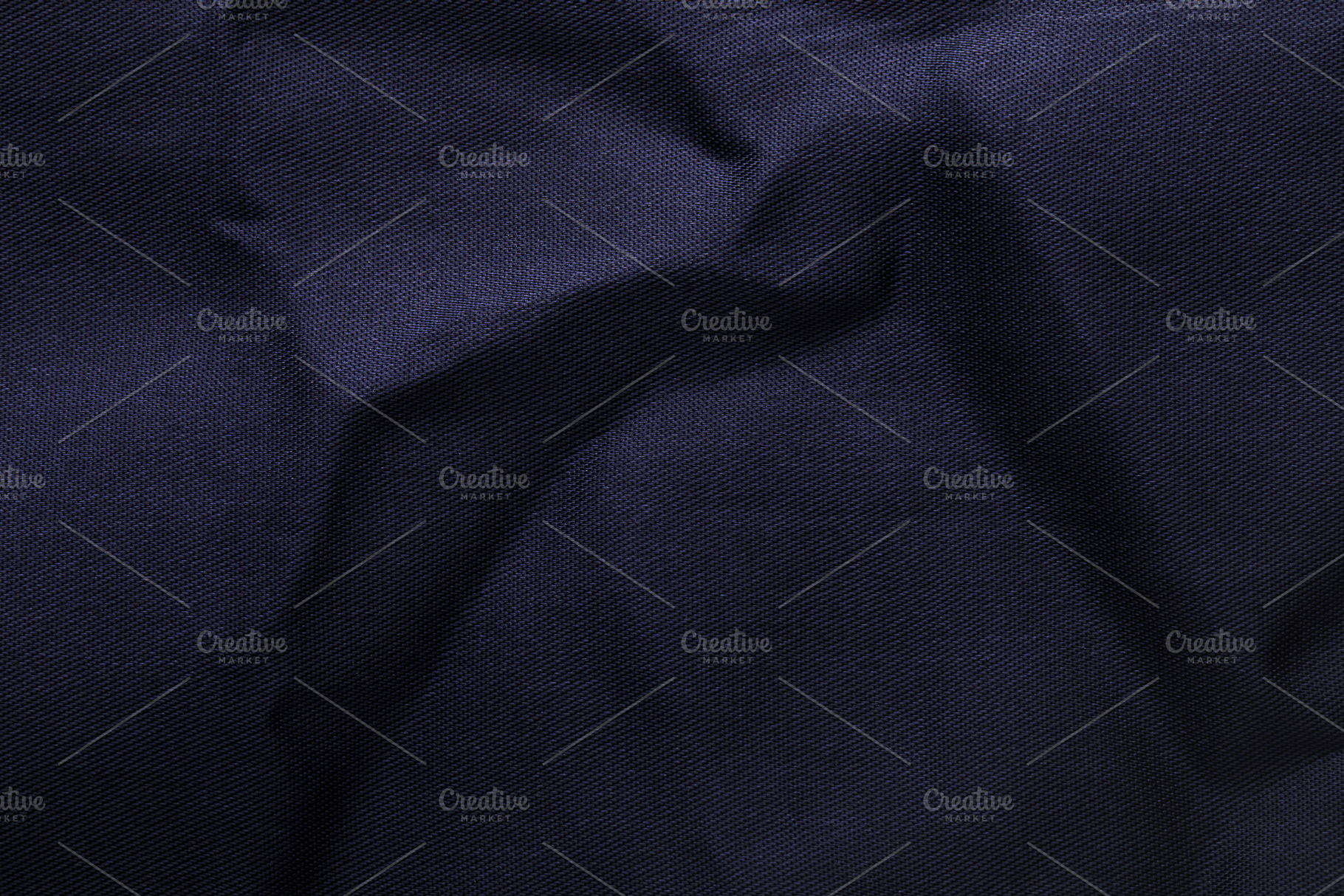 Close-up of dark blue textile with soft folds and subtle texture, a Background Photo by Ales Munt
