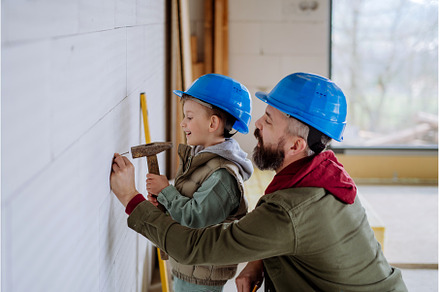 Father and his little son working on, a Person Photo by HalfPoint