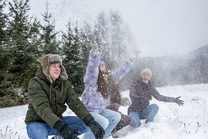 Family throwing snow into air during, a Sports & Recreation Photo by HalfPoint