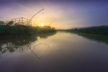 Platform with fishing net at sunset