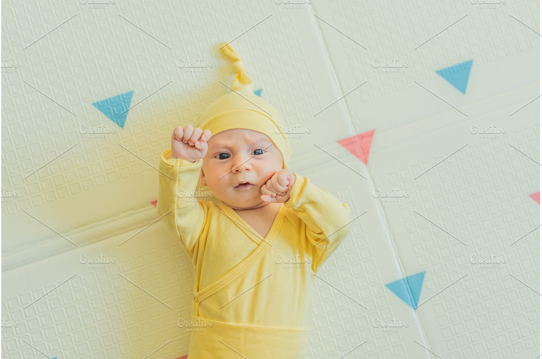 Adorable baby in a yellow hat lying, a Person Photo by Elizaveta Galitskaya