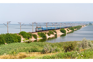 Passenger electric train on a dam, a Transportation Photo by Leonid Andronov