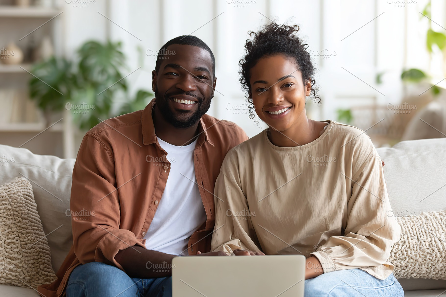 Couple enjoying quality time together while working on a laptop at home, a Photo by AlyaAnd