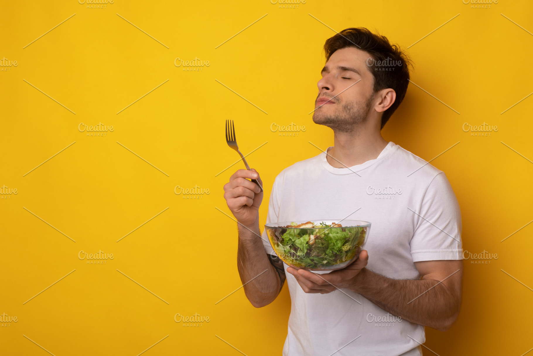 Portrait of Smiling Guy Holding Bowl With Salad, a Photo by Prostock-Studio