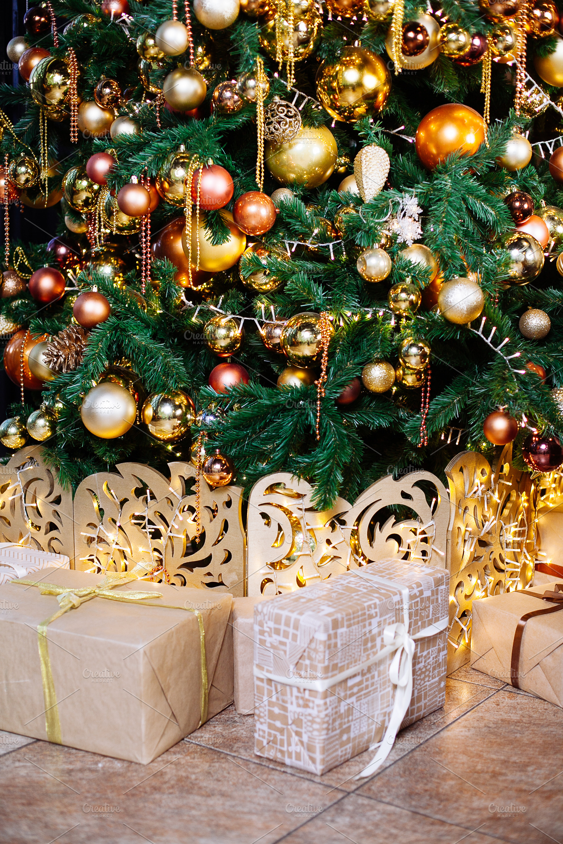 Decorated christmas tree in gold and containing ball, bauble, and bead, a Holiday Photo by telnyaw