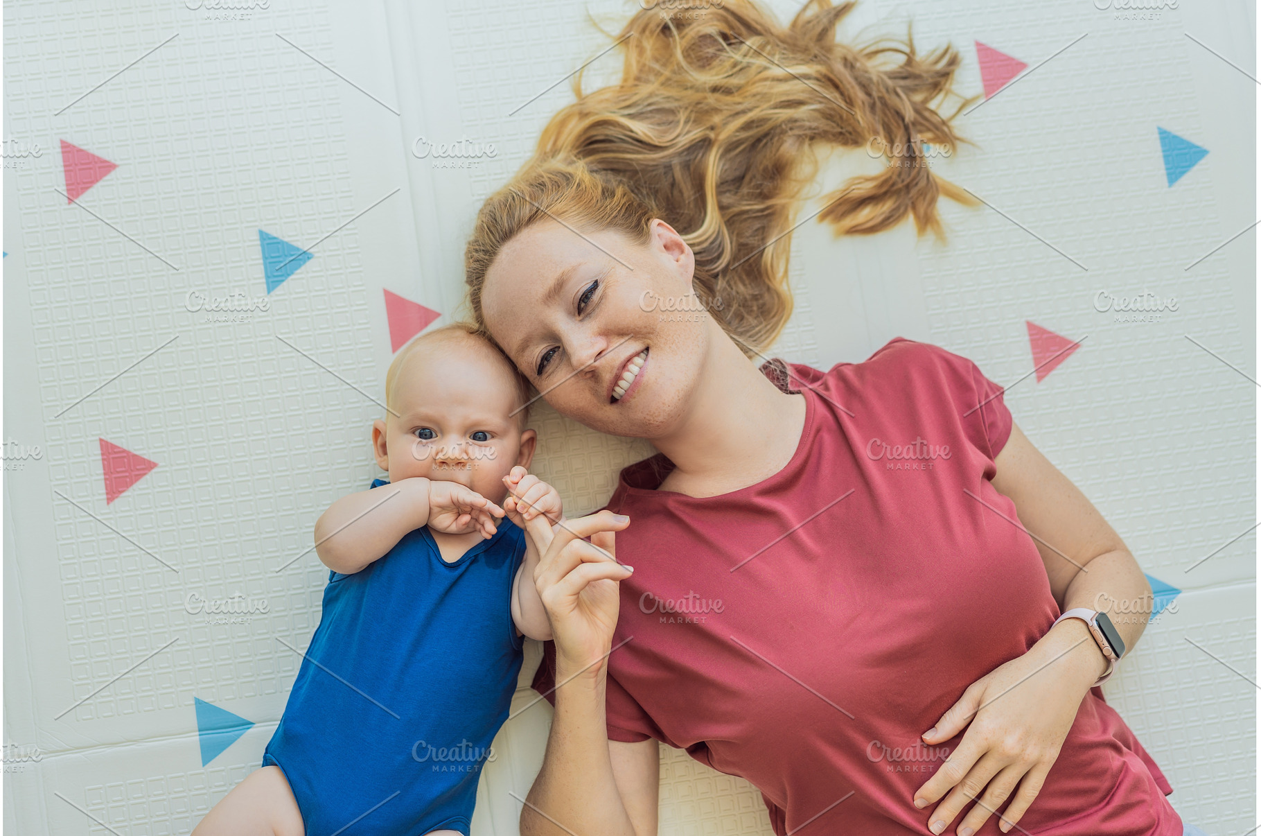 Mother and baby lying on a soft play, a Person Photo by Elizaveta Galitskaya