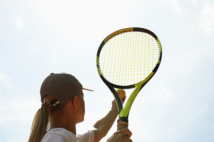 Young woman in white t-shirt serve the tennis ball, a Sports & Recreation Photo by AtlasStudio PRO