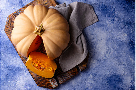 Raw fresh cut pumpkin on dark