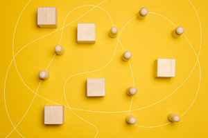 Wooden figures of men and a trajectory between obstacles on a ye, an Abstract Photo by ndanko