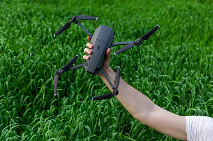 The guy holds a quadrocopter, a Technology Photo by Photostock