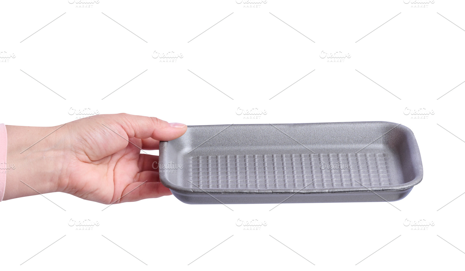 A woman's hand holding an empty grey foam food tray on isolated, a Food & Drink Photo by ndanko