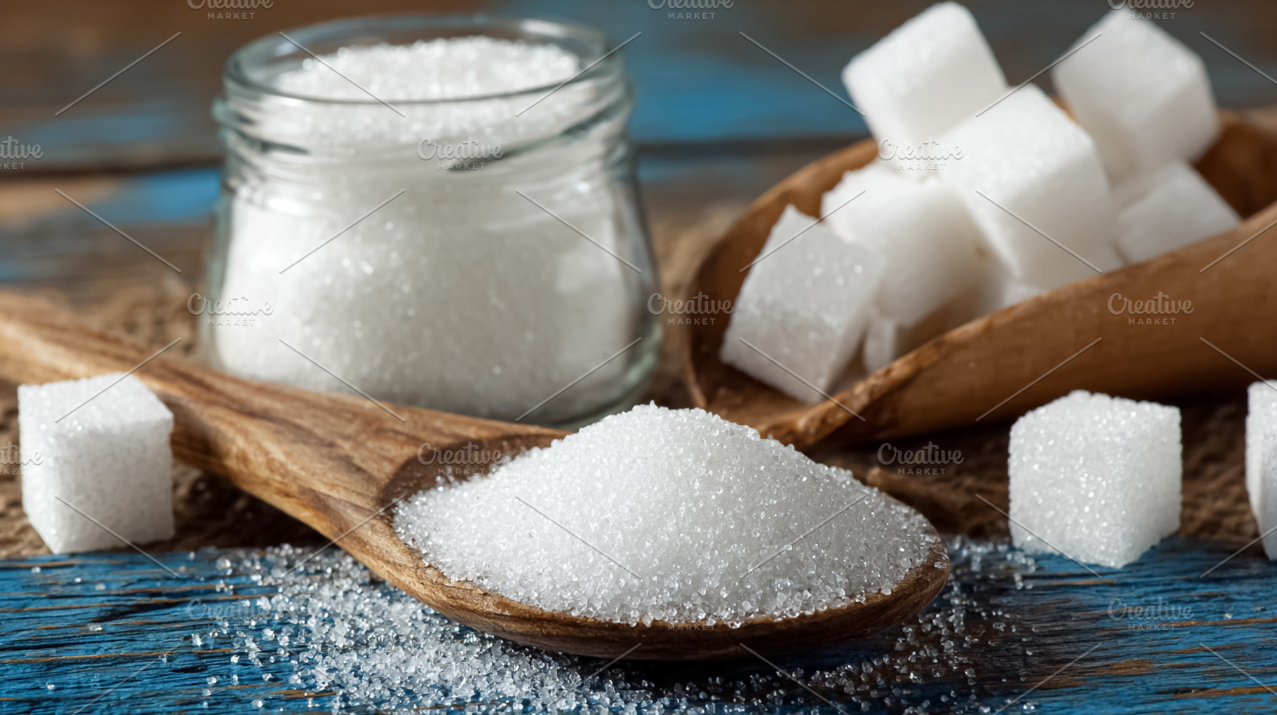 White sugar in granular and cube forms, a sweet food ingredient, a Photo by Studio ANNA