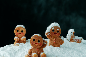 group of gingerbread men in snow, a Photo by Nito