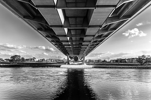 Under the bridge featuring bridge, water, and beneath