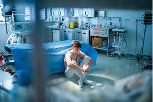 Teenage boy sitting depressed on, a Health & Medical Photo by HalfPoint