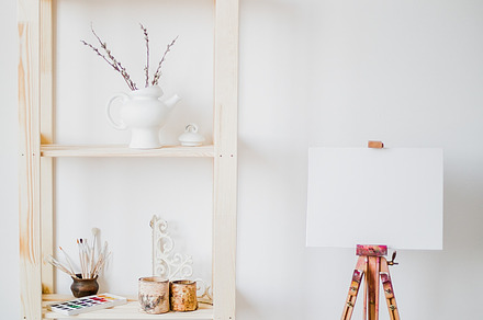 Easel paints background containing easel, artist, and canvas