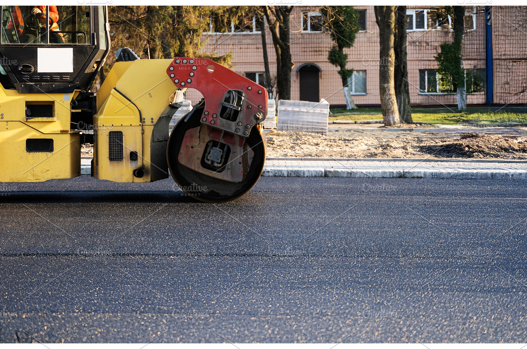 Road roller machine compacts fresh, an Industrial Photo by volodymyrshtun13795