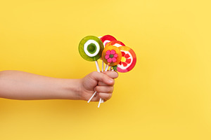 Close-up of a child’s hand holding a bunch of vibrant, fruit-s, a Food & Drink Photo by Ales Munt