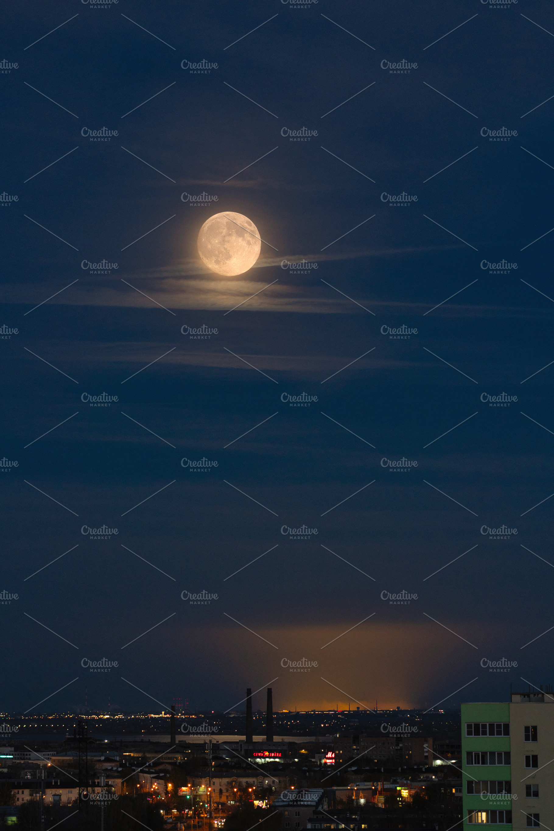 Full moon rising above illuminated, a Wallpaper Photo by Elena Vagengeim