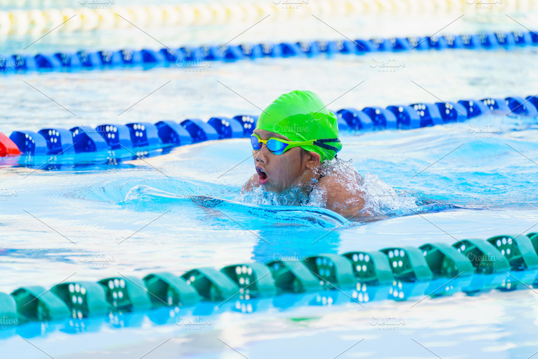 Swimmer child swims breaststroke swimming style in a race swimmi, a Sports & Recreation Photo by Casanowe-studio
