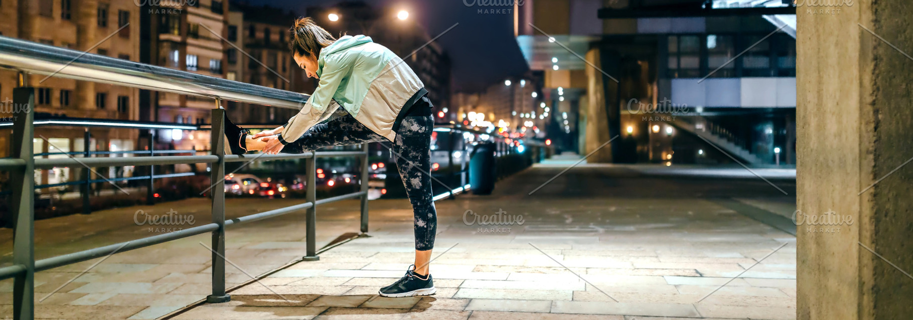 Woman runner stretching her legs over banister before training a, a Sports & Recreation Photo by davidpereiras
